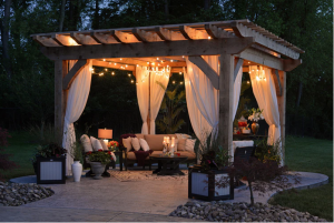 a gazebo with side curtains and lights